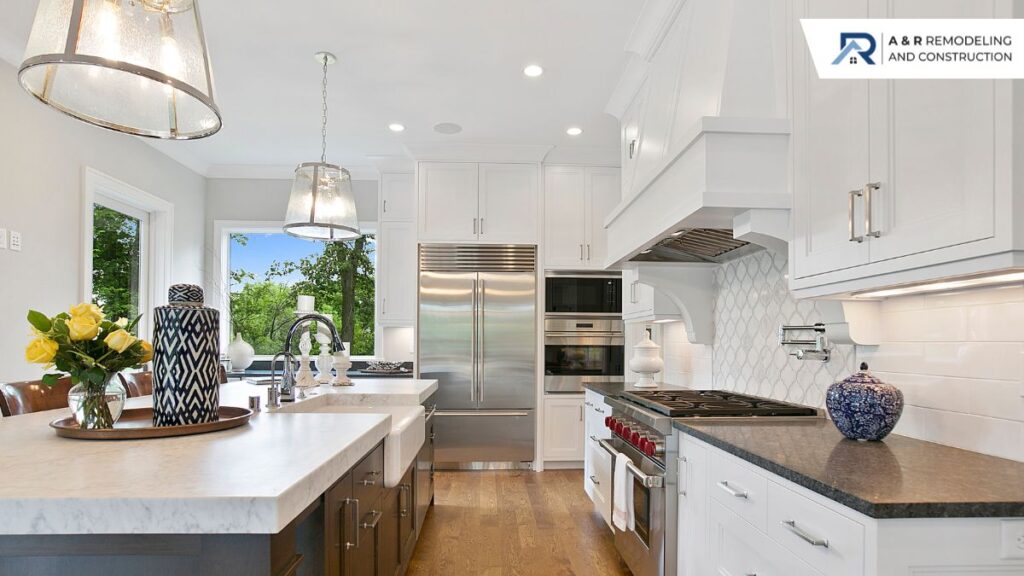 A modern kitchen featuring white cabinets and countertops, creating a bright and clean aesthetic.